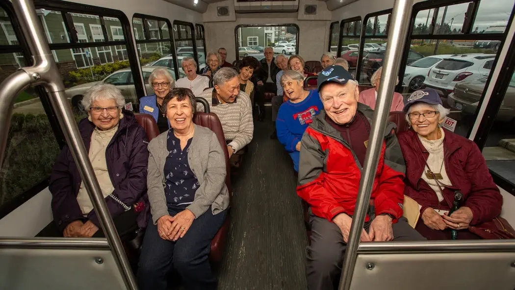 Seniors enjoying transportation on a community bus.