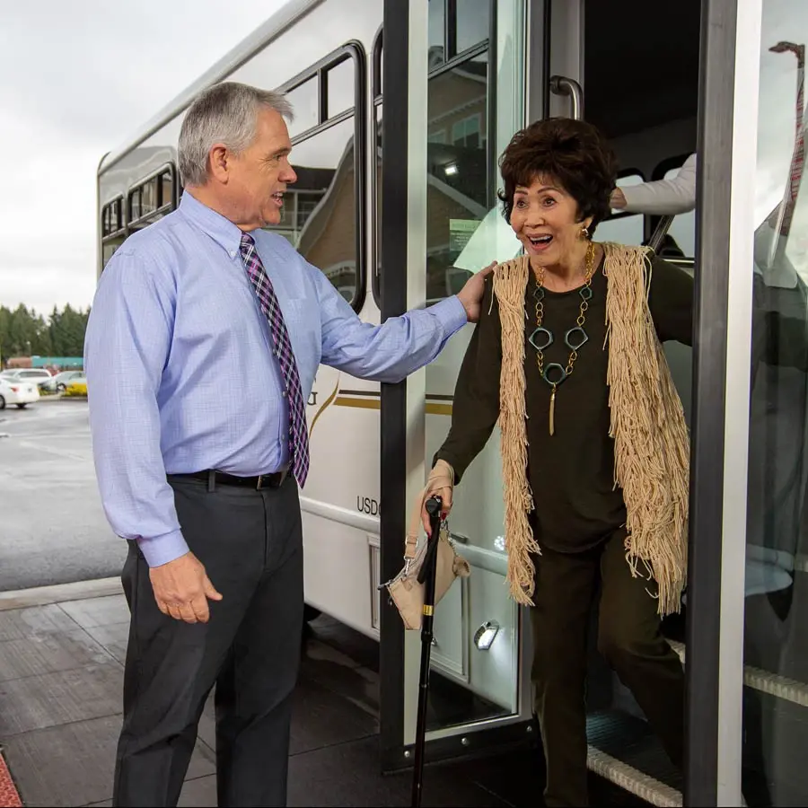 Cardinals Perch man helping lady off bus